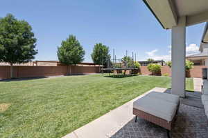 View of yard featuring a trampoline and a patio area