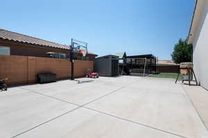 Fenced backyard with a patio