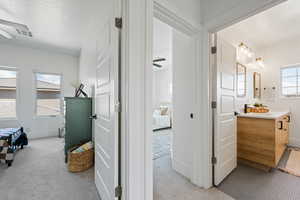 Corridor with light carpet and baseboards