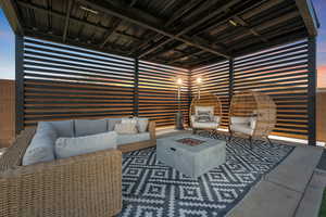 View of patio featuring an outdoor living space with a fire pit