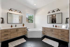 Full bath featuring two vanities, a garden tub, tile patterned floors, and recessed lighting