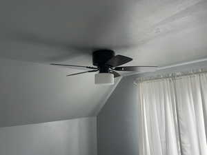 Detailed view of ceiling fan and a textured ceiling