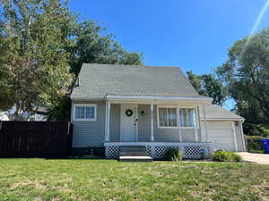 Bungalow-style house featuring a porch, driveway, and a shingled roof