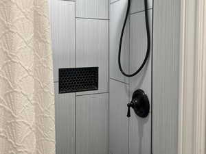 Full bathroom with tiled shower