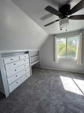 Additional living space with carpet floors, lofted ceiling, and a ceiling fan