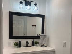 Bathroom with vanity and baseboards