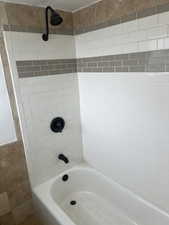 Bathroom featuring washtub / shower combination