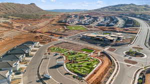 Aerial view of property's location featuring a mountain backdrop and nearby suburban area