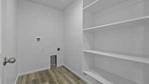 Laundry area featuring electric dryer hookup, hookup for a washing machine, wood finished floors, and baseboards