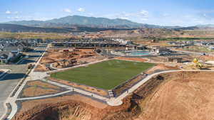 Aerial view of property and surrounding area with a mountainous background