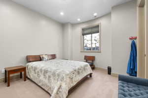Carpeted bedroom with recessed lighting and baseboards
