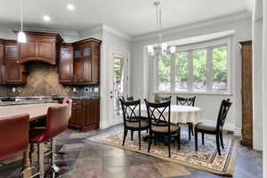 Dining room featuring plenty of natural light, a chandelier, crown molding, baseboards, and recessed lighting