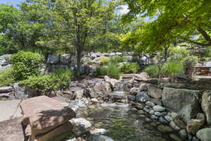 View of yard with a garden pond