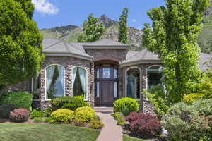 View of front of property with stone siding and a mountain view
