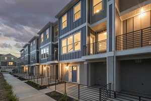 View of property at dusk