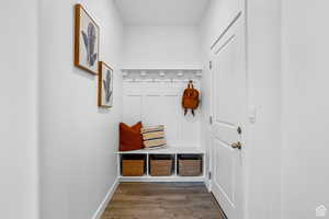 Mudroom with dark wood-style flooring and baseboards