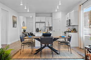 Dining area featuring light wood-style flooring, baseboards, and recessed lighting