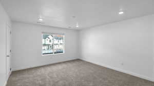 Unfurnished room with carpet floors, recessed lighting, and baseboards