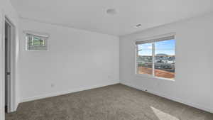 Unfurnished room with carpet and baseboards