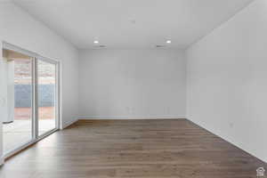Unfurnished room featuring recessed lighting, wood finished floors, and baseboards