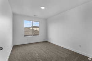 Unfurnished room featuring carpet flooring and baseboards