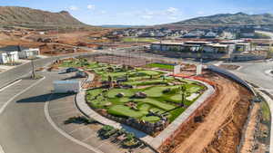 Aerial view of residential area featuring mountains and a golf course