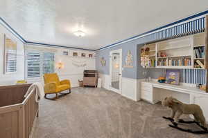 Living area featuring carpet and crown molding