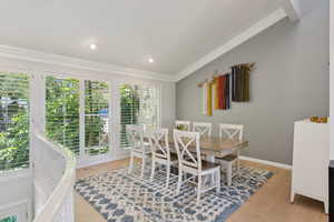 Dining room with crown molding, wood finished floors, baseboards, and recessed lighting