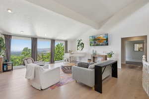 Living room with healthy amount of natural light, light wood-style flooring, recessed lighting, and baseboards