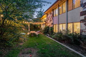 View of green lawn featuring a balcony
