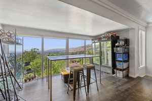 Sunroom / solarium featuring a mountain view