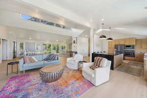 Living room featuring high vaulted ceiling and recessed lighting