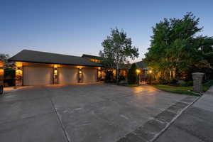 View of front of property with driveway and a garage