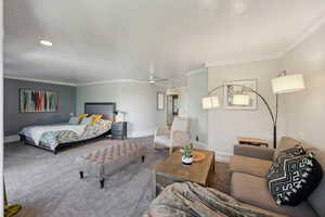 Bedroom with carpet flooring, baseboards, crown molding, and recessed lighting