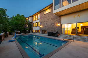 Outdoor pool featuring a patio area, entry steps, and grilling area