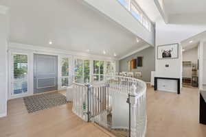 Entryway with light wood-type flooring, crown molding, baseboards, and recessed lighting