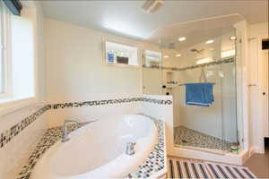 Bathroom with a bath, a shower stall, and recessed lighting