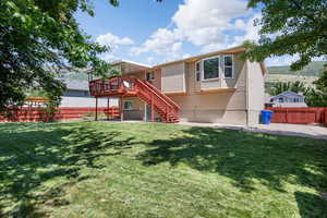Back of house with stairs, a deck, and a patio