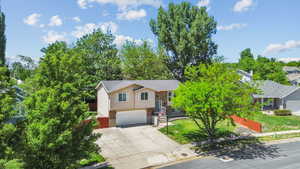 View of front of home with driveway, an attached garage, and brick siding