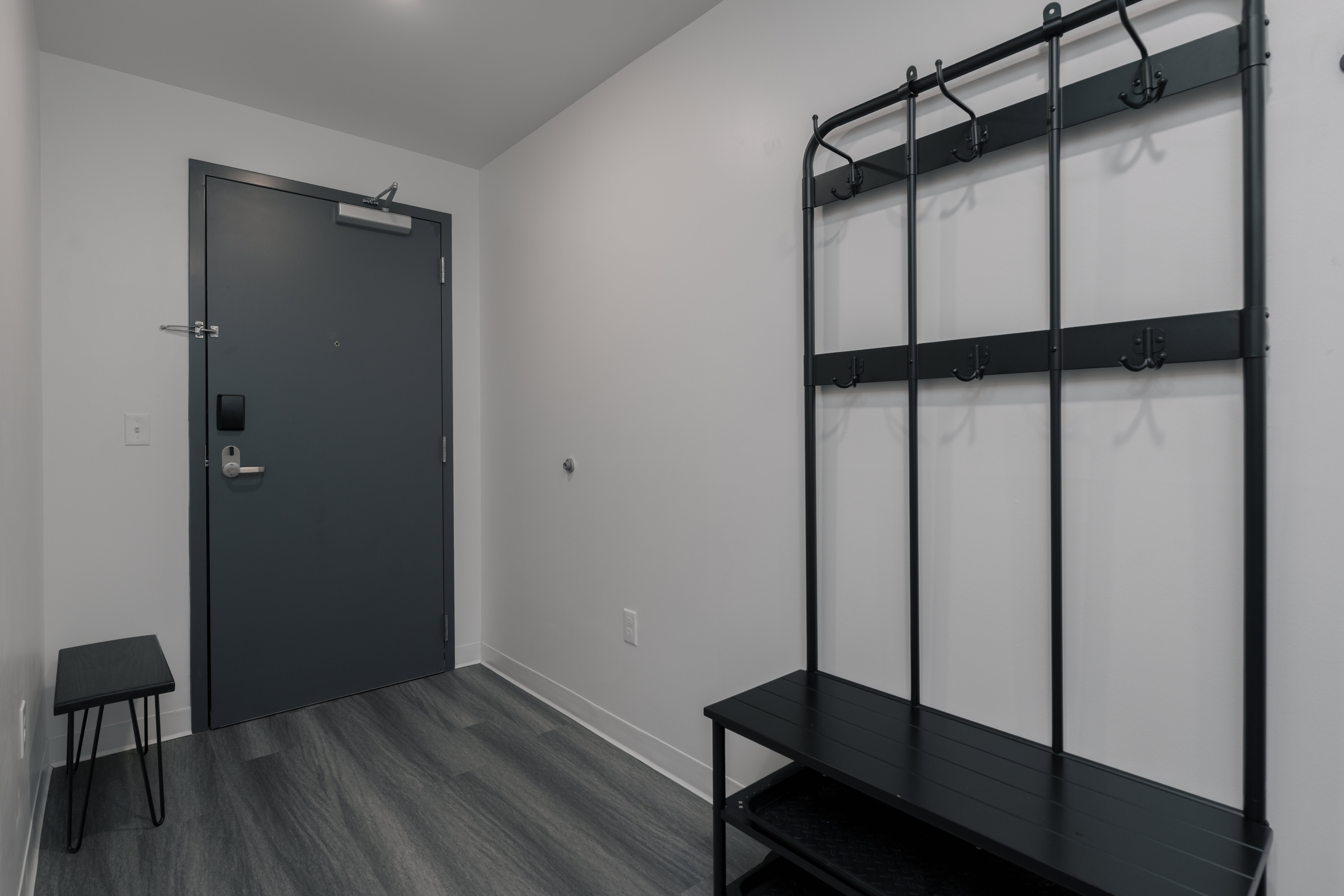 Mudroom featuring baseboards and dark wood-style flooring