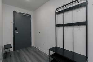 Mudroom featuring baseboards and dark wood-style flooring