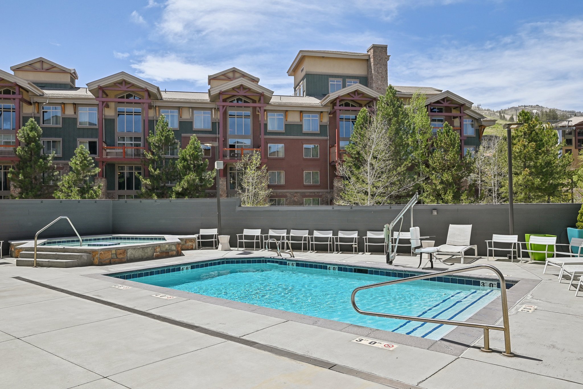 Community pool with a community hot tub and a patio area