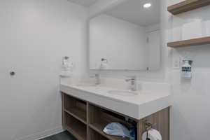 Bathroom with double vanity and recessed lighting