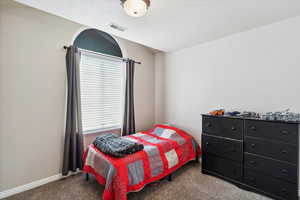 Bedroom featuring carpet and baseboards