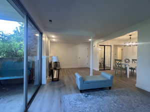 Living area with wood finished floors and a chandelier