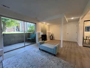 Sitting room with wood finished floors and recessed lighting