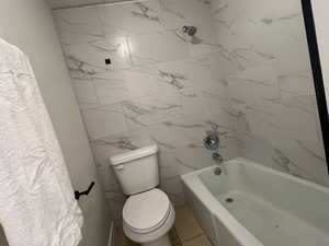 Full bathroom featuring toilet and shower / washtub combination