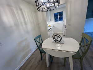 Dining area featuring a chandelier and wood finished floors