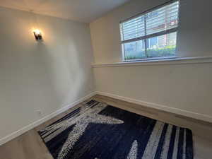 Empty room with baseboards and wood finished floors