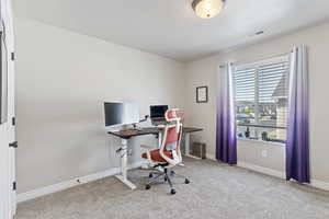 Home office with carpet and baseboards